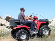 A man riding a 4 wheeler